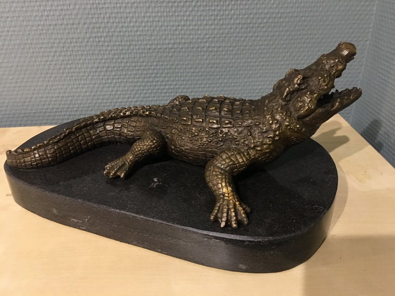 Bronze crocodile on oval natural stone base