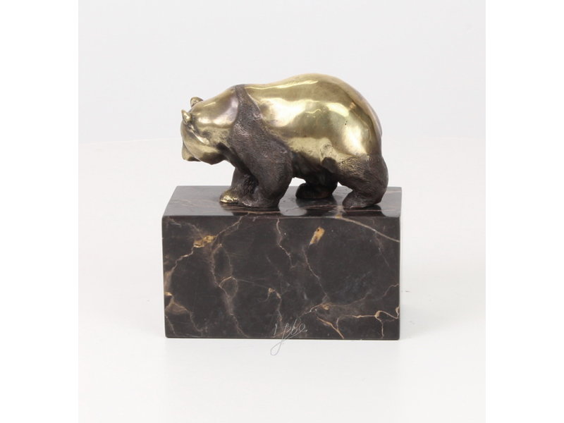 Walking panda bear made of bronze on a block of veined natural stone