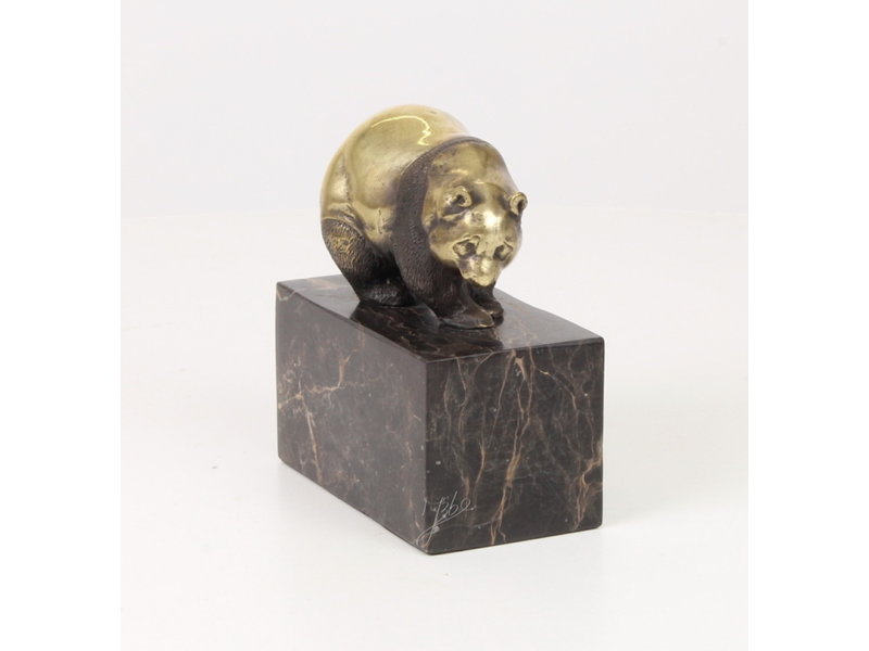 Walking panda bear made of bronze on a block of veined natural stone