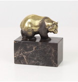 Walking panda bear made of bronze on a block of veined natural stone