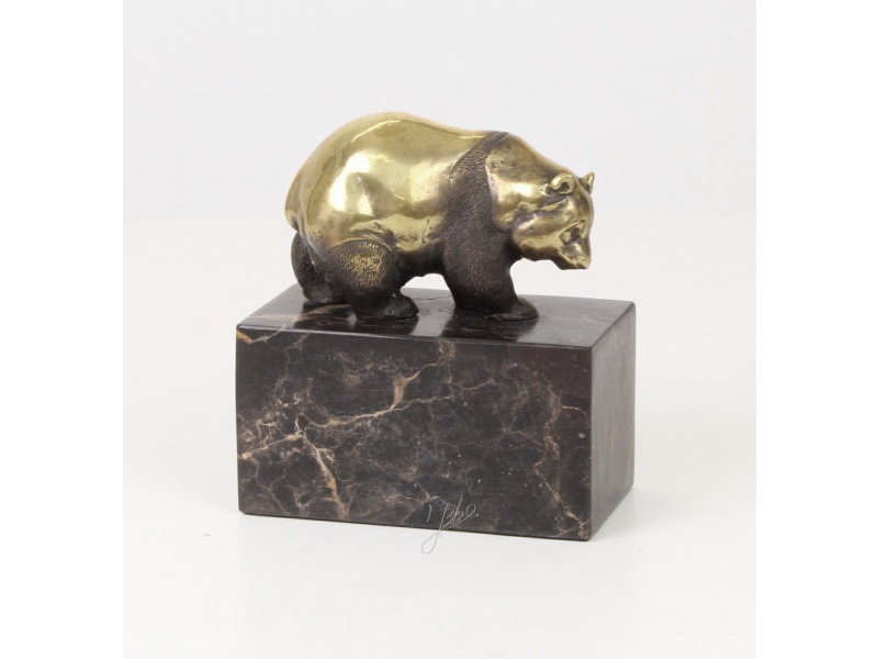 Walking panda bear made of bronze on a block of veined natural stone