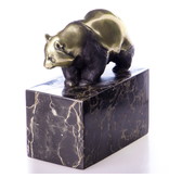 Walking panda bear made of bronze on a block of veined natural stone