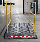 Construction site footbridge with yellow handrails