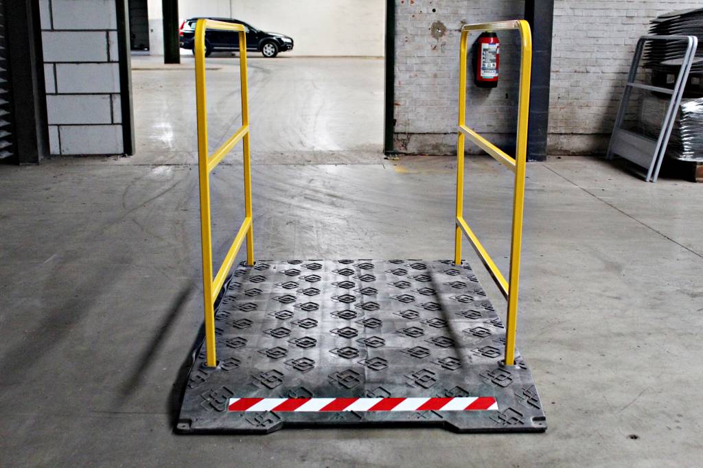 Construction site footbridge with yellow handrails