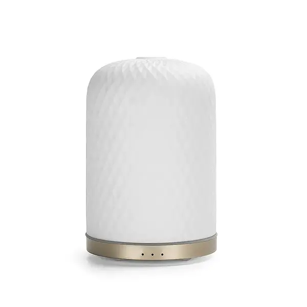 Wasgeluk Diffuseur Mozzin Tino - Rafraîchissement et Bien-être à la Maison ! Avec un fond doré et un extérieur en porcelaine, Tino est non seulement esthétique, mais apporte également des parfums agréables et une humidité améliorée de l'air. L'arrêt automatique et