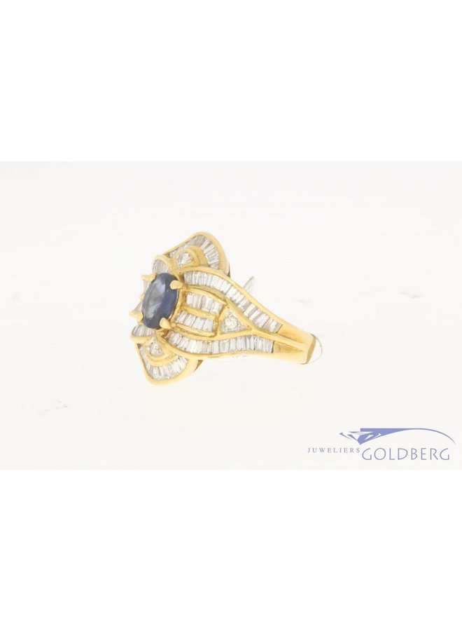 18 carat gold ring with baguette cut diamond and blue sapphire