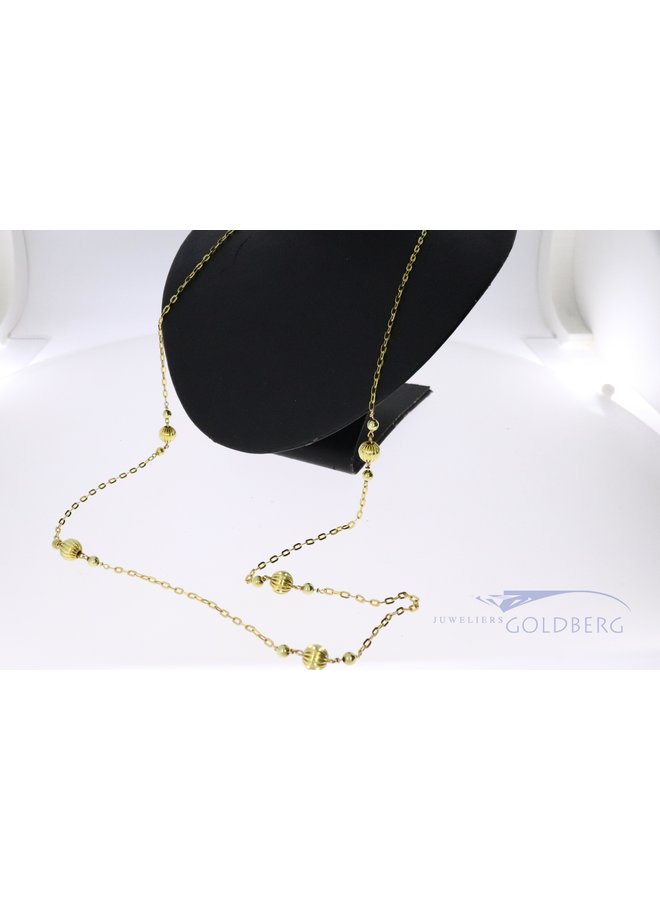 14k gold anchor necklace with decorative gold beads.