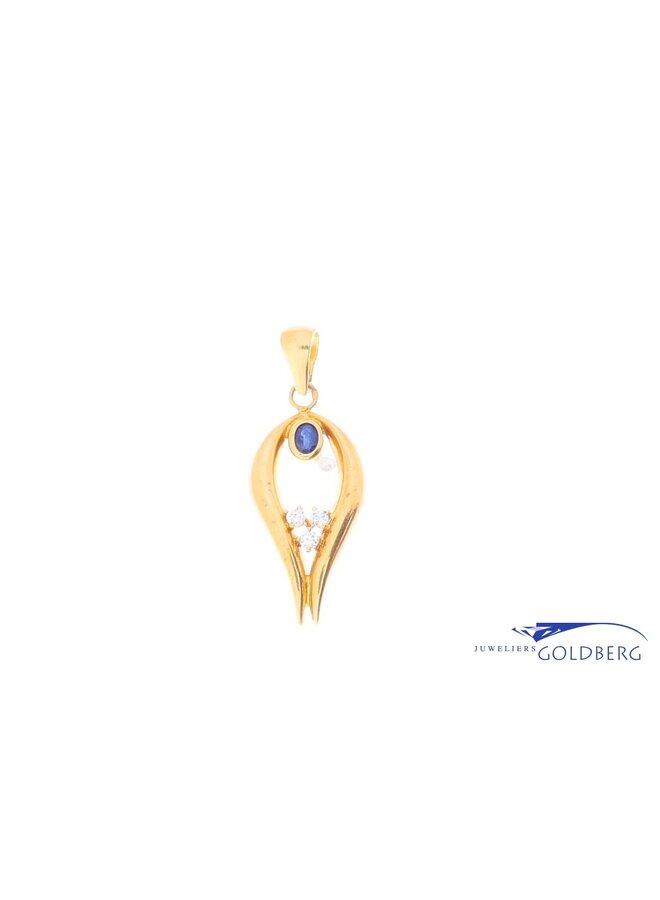 18k gold pendant with a synth blue sapphire and zirconia
