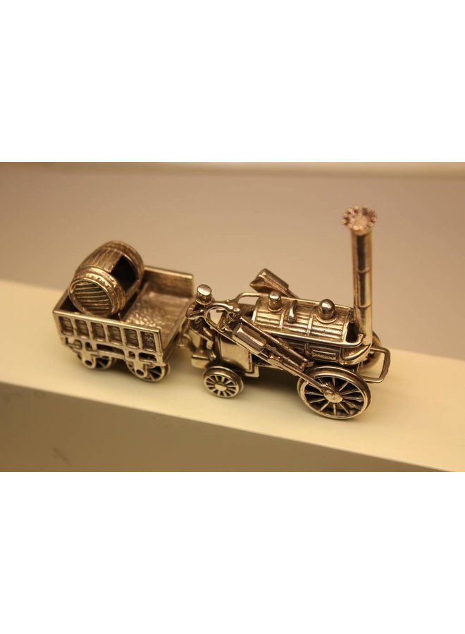 Miniature silver locomotive with coal wagon